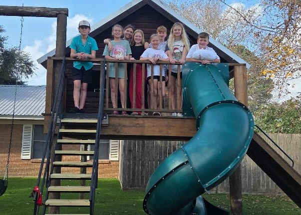 Children laughing and playing on the playground at St. John Lutheran Church Cat Spring.