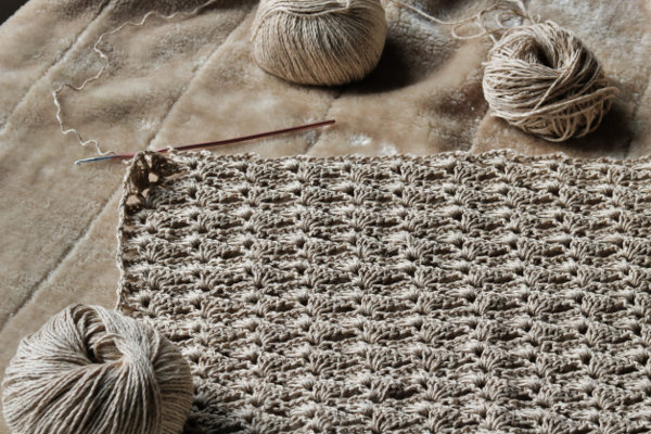 Hand-crocheted prayer shawl in natural cream yarn, created by the Prayer Shawl Ministry of St. John Lutheran Church Cat Spring.
